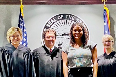 Judges Hensal, Teodosio, and Sutton with student